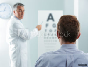 A male patient getting his yearly eye exam by reading a schell exam